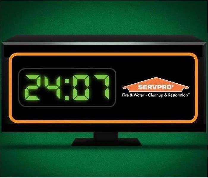 An alarm clock displaying the time 24:07 with the SERVPRO logo.